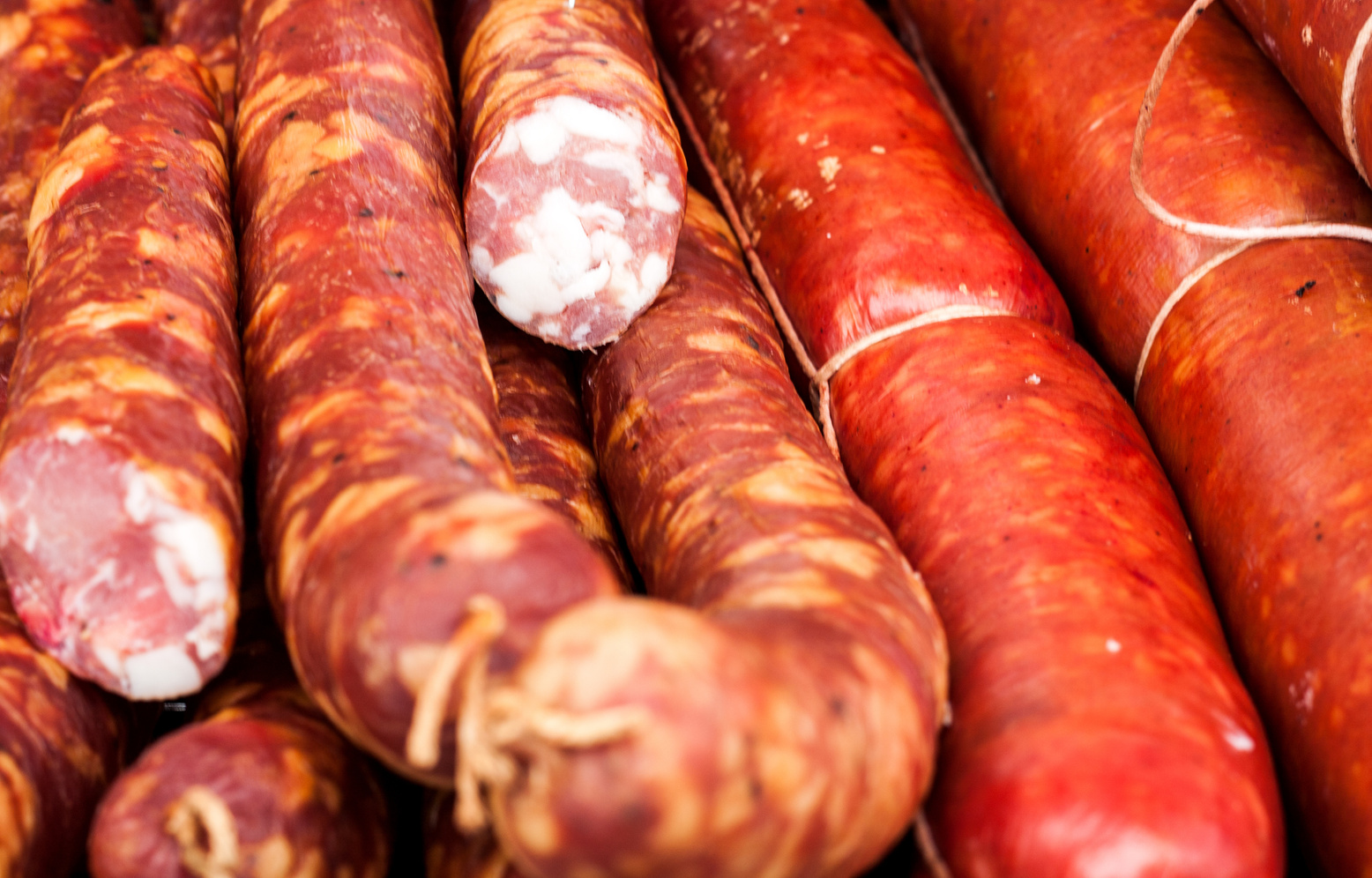 many sausages in natural casing as a background